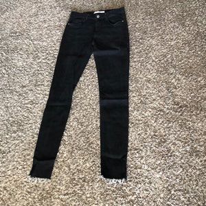 Black skinny jeans with fray bottoms